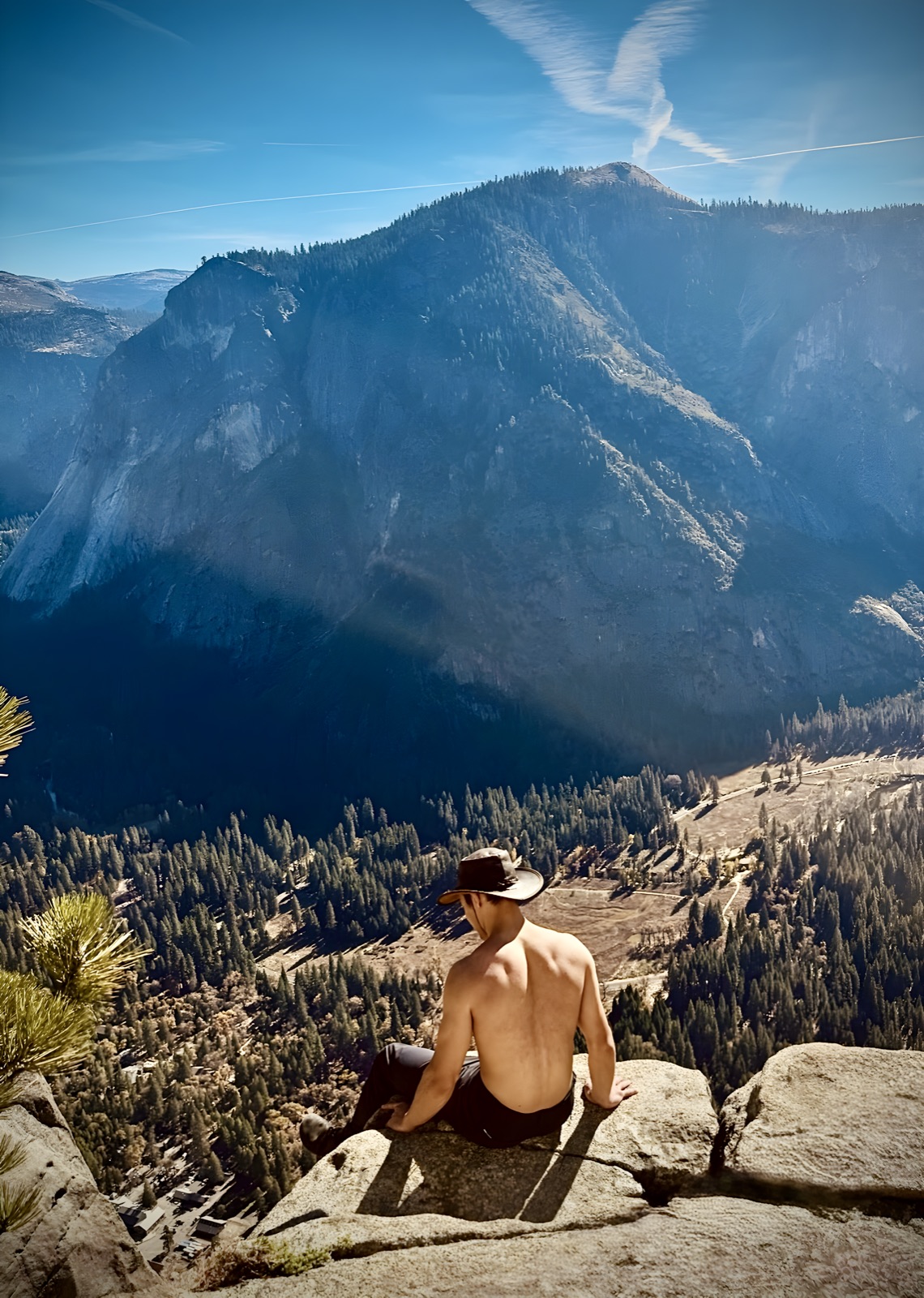 Jordan sitting on a cliff edge above Yosemite Valley